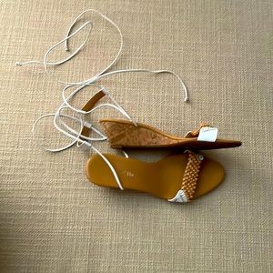 Wedged white sandals with beaded design at toe.